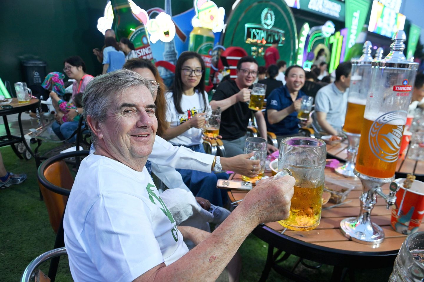 QINGDAO, CHINA - JULY 24, 2024 - Tourists enjoy a drink in a beer pong at the Golden Beach Beer City in Qingdao, East China&#039;s Shandong province, July 24, 2024. (Photo credit should read CFOTO/Future Publishing via Getty Images)