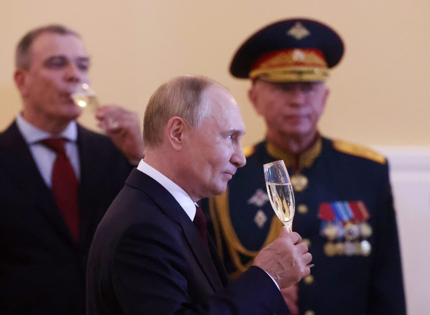 SAINT PETERSBURG, RUSSIA - JULY 28 (RUSSIA OUT) Russian President Vladimir Putin (C) drinks champaigne as Deputy Defence Minister Alexander Fomin (R) looks on during a reception for Naval officers after the military parade, marking the Navy Day, on July 28 2024, in Saint Petersburg, Russia. 25 boats and ships, a submarine, and 2500 military servicemen took part in the parade. (Photo by Contributor/Getty Images)